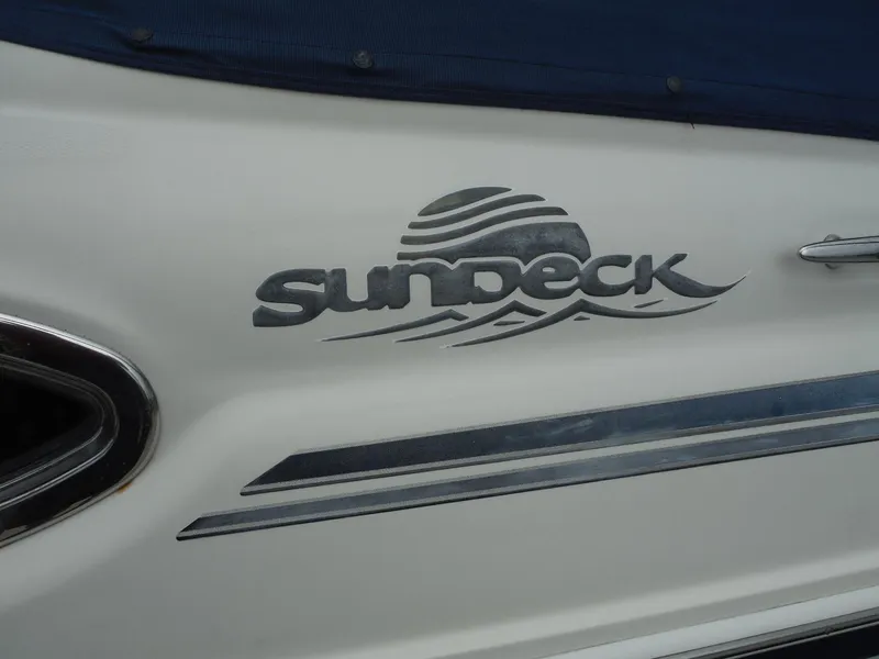 Slide: The Image of 2007 Sea Ray 240 Sundeck logo on white boat hull. - 33