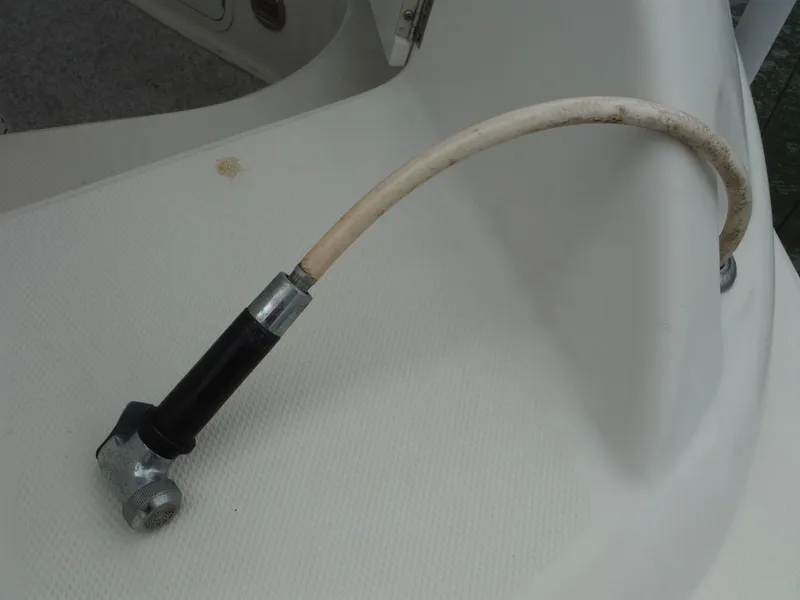 Slide: The Image of 2007 Sea Ray 240 Sundeck boat deck with hose attachment. - 21
