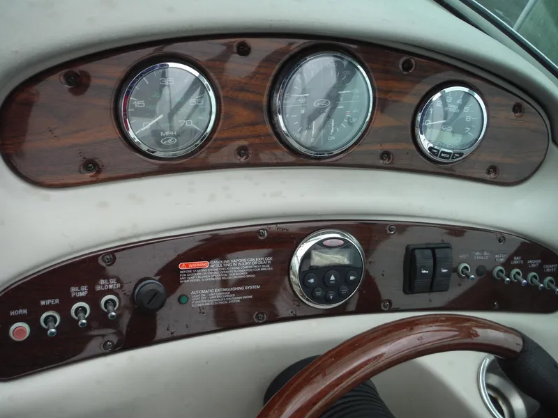 Slide: The Image of Dashboard of a 2007 Sea Ray 240 Sundeck boat with gauges and controls. - 25