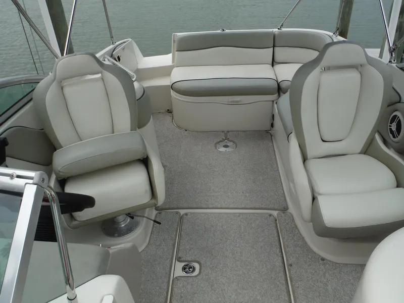 Slide: The Image of 2007 Sea Ray 240 Sundeck interior with cushioned seating and steering wheel. - 9