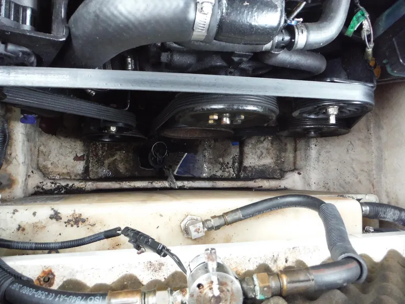 Slide: The Image of 2007 Sea Ray 240 Sundeck engine compartment with visible belts and hoses. - 18