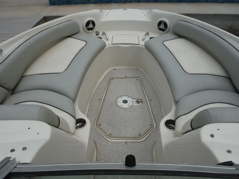 Slide: The Image of 2007 Sea Ray 240 Sundeck bow seating area with gray cushions. - 8