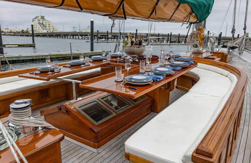 Slide: The Image of Luxurious 1929 Lyman-Morse Staysail Schooner with elegant outdoor dining setup. - 15