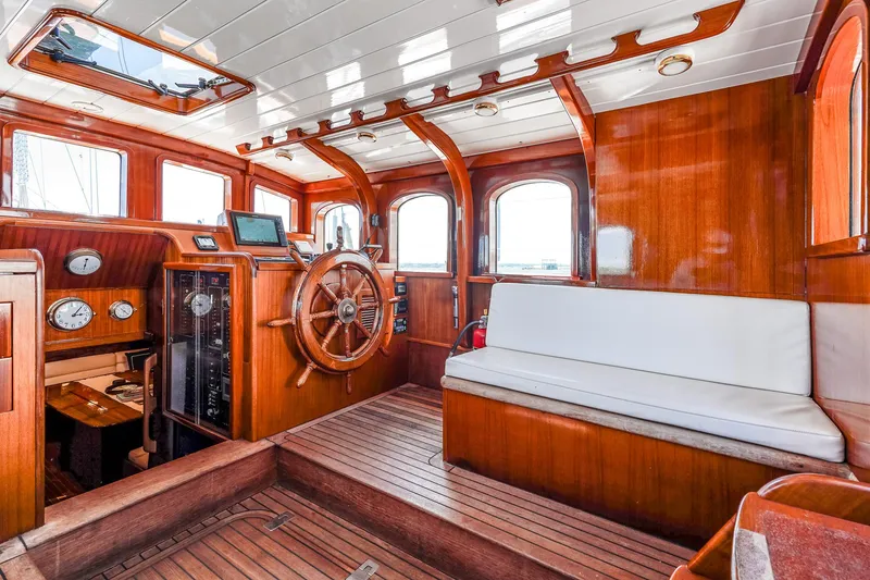 Slide: The Image of Interior of 1929 Lyman-Morse Staysail Schooner with wooden helm and seating. - 21
