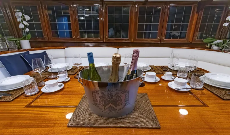 Slide: The Image of Elegant dining setup on a 1929 Lyman-Morse Staysail Schooner with wine bottles in an ice bucket. - 29
