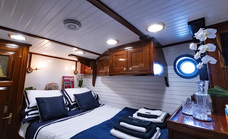 Slide: The Image of Luxurious cabin interior of 1929 Lyman-Morse Staysail Schooner with elegant woodwork and nautical decor. - 39