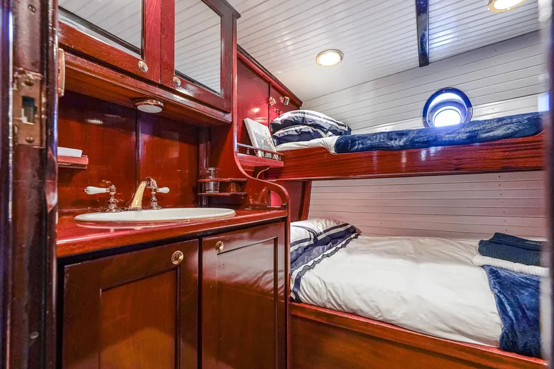 Slide: The Image of Luxurious 1929 Lyman-Morse Staysail Schooner cabin with wooden interior and cozy bunk beds. - 44