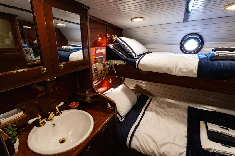 Slide: The Image of Cozy cabin interior of 1929 Lyman-Morse Staysail Schooner with bunk beds and sink. - 48