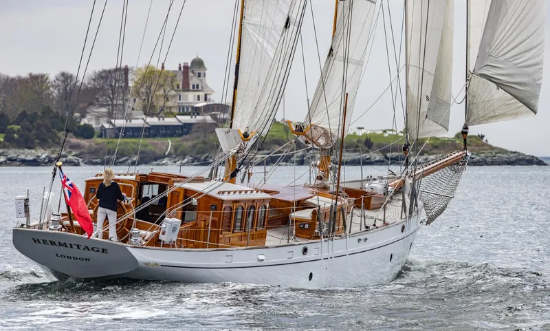 Slide: The Image of 1929 Lyman-Morse Staysail Schooner Hermitage sailing near a coastal estate. - 54