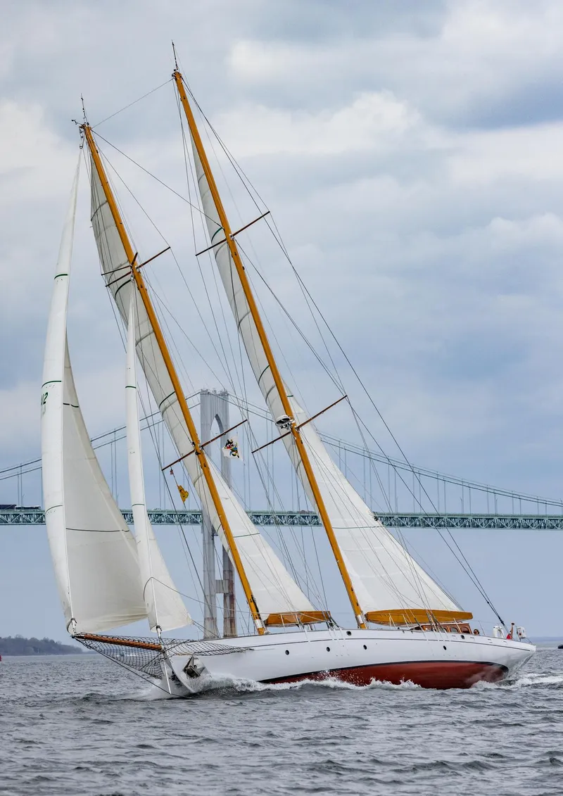 Slide: The Image of 1929 Lyman-Morse Staysail Schooner sailing near a bridge on a cloudy day. - 62
