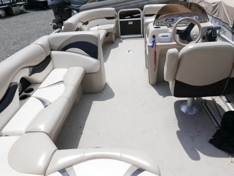 Slide: The Image of 2012 Sylvan Mirage 820 pontoon boat interior with beige and black seating. - 10