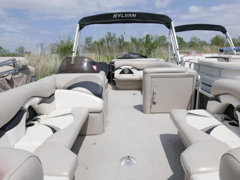 Slide: The Image of 2012 Sylvan Mirage 820 pontoon boat with beige seating and canopy. - 3