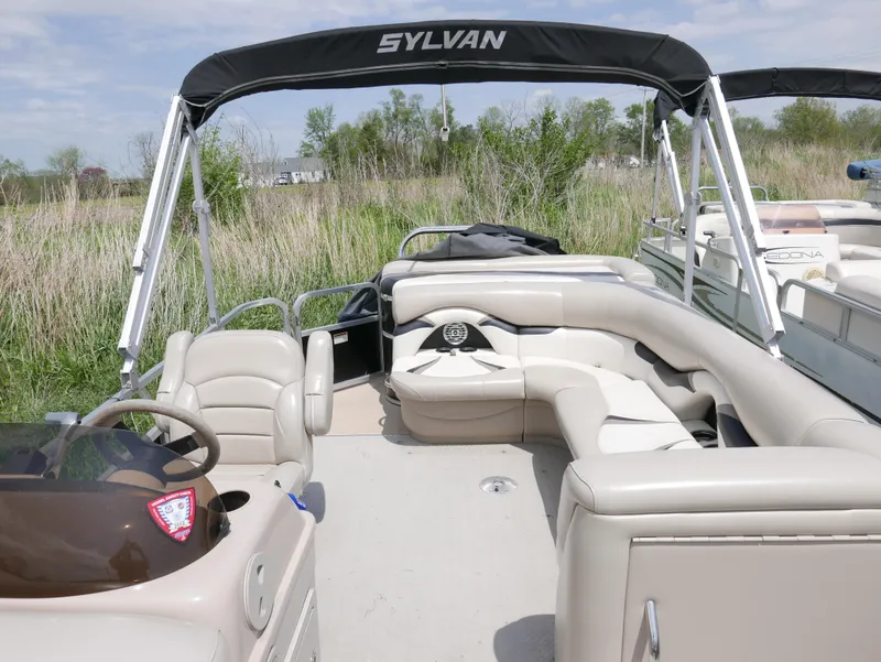 Slide: The Image of 2012 Sylvan Mirage 820 pontoon boat with beige seating and canopy. - 5