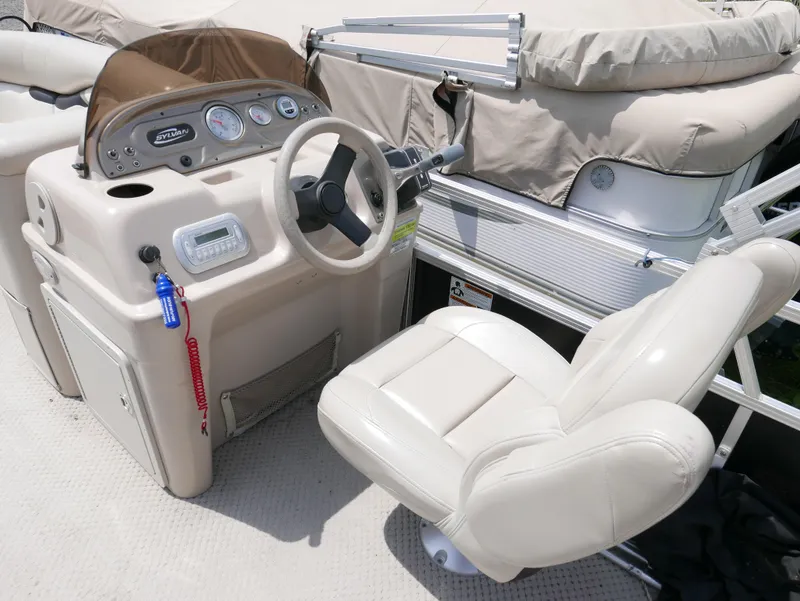 Slide: The Image of 2012 Sylvan Mirage 820 boat cockpit with steering wheel and captain's chair. - 6