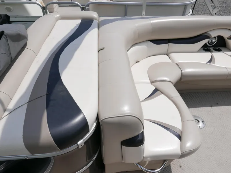 Slide: The Image of 2012 Sylvan Mirage 820 boat interior with beige and black seating. - 9
