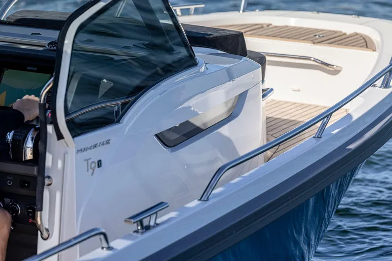 Slide: The Image of 2024 Nimbus Tender 9 boat cruising on water, showcasing sleek design and modern features. - 6