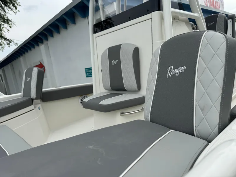 Slide: The Image of 2024 Ranger 2510 boat with gray and white cushioned seats. - 10
