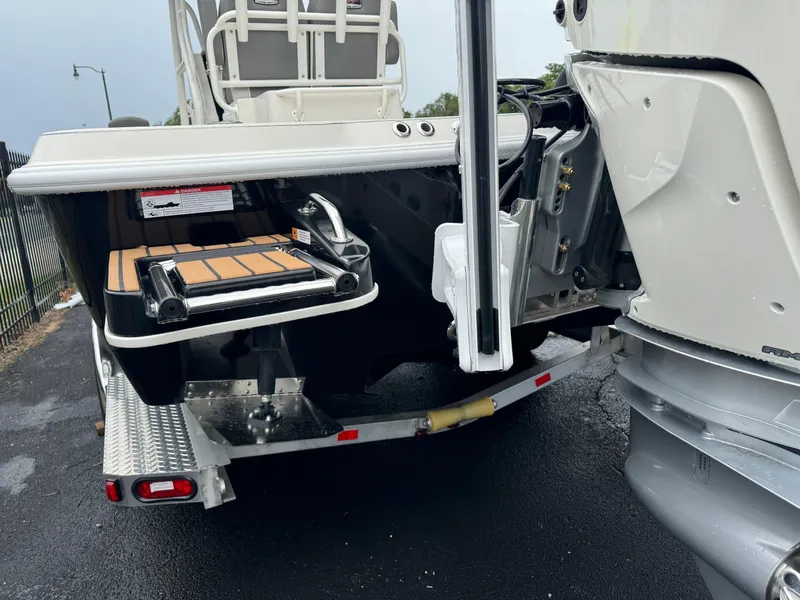 Slide: The Image of 2024 Ranger 2510 boat rear view with swim platform and motor. - 18