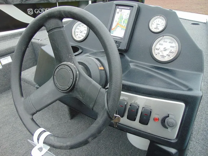 Slide: The Image of 2024 Crestliner 1600 Storm boat dashboard with steering wheel and navigation system. - 10