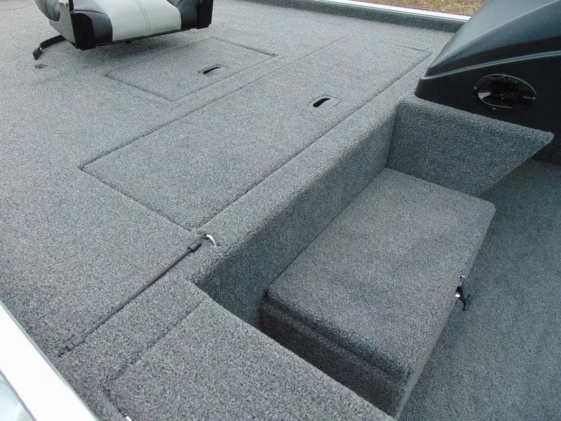 Slide: The Image of 2024 Crestliner 1600 Storm boat interior with gray carpeted deck and seating. - 4