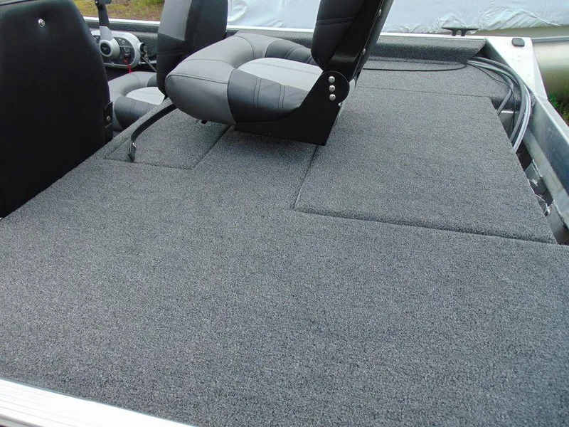 Slide: The Image of 2024 Crestliner 1600 Storm boat interior with grey carpet and seating. - 6