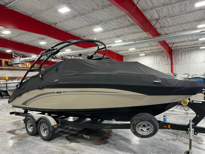 Slide: The Image of 2013 Yamaha Boats 242 Limited S covered on trailer in indoor storage. - 13