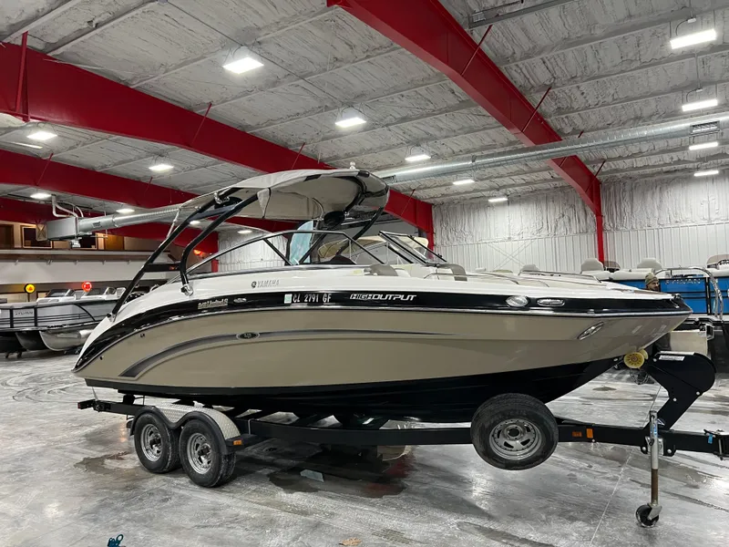Slide: The Image of 2013 Yamaha Boats 242 Limited S on trailer in indoor storage facility. - 2