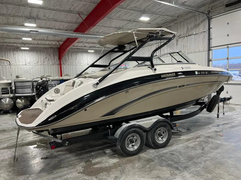 Slide: The Image of 2013 Yamaha Boats 242 Limited S in a garage on a trailer. - 3