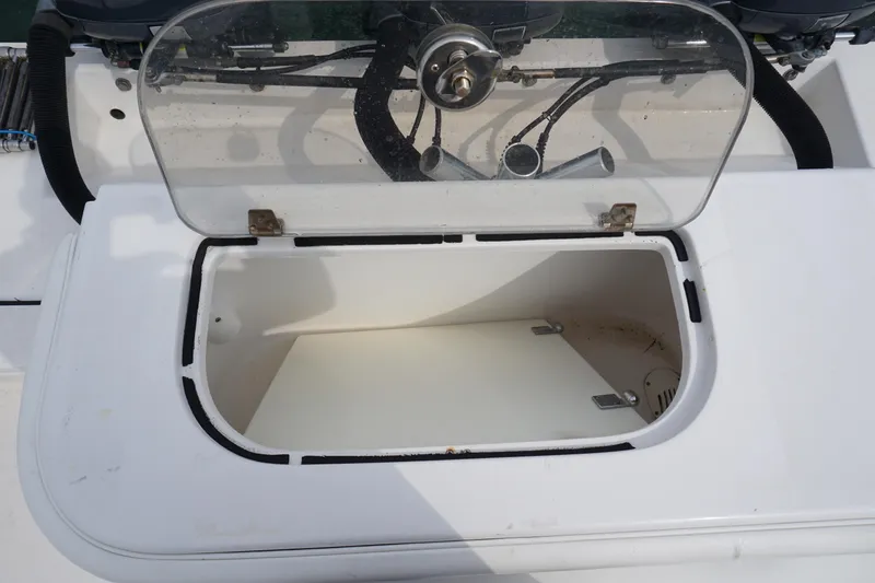 Slide: The Image of Open storage compartment on a 2006 Contender 36 Cuddy boat. - 15
