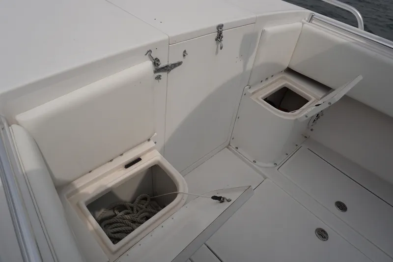 Slide: The Image of 2006 Contender 36 Cuddy boat storage compartments and seating area. - 17