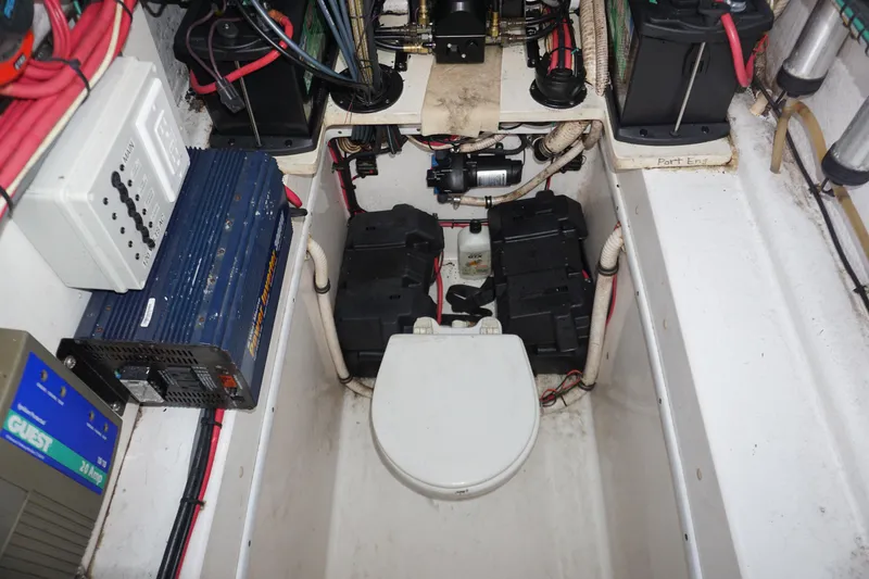 Slide: The Image of 2006 Contender 36 Cuddy boat engine room with batteries and electrical components. - 23