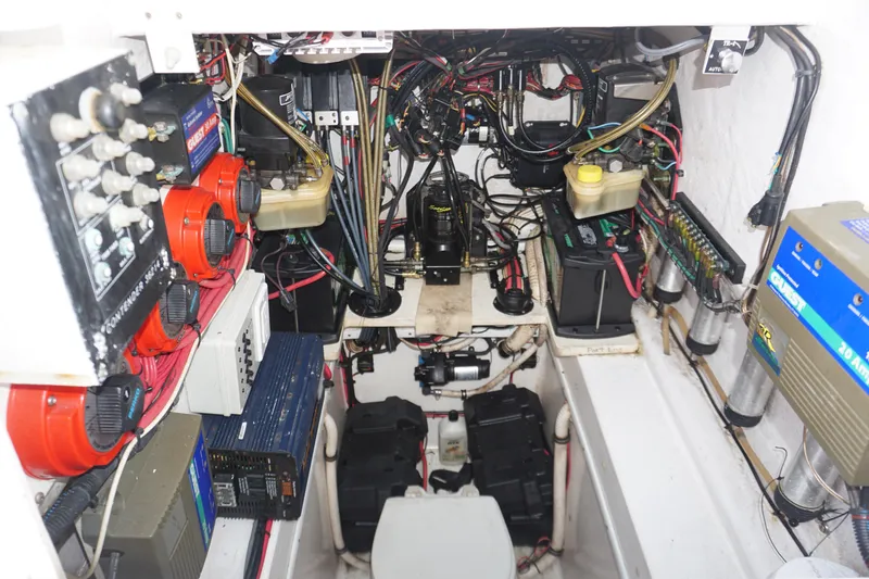 Slide: The Image of 2006 Contender 36 Cuddy engine room with wiring and battery systems. - 25