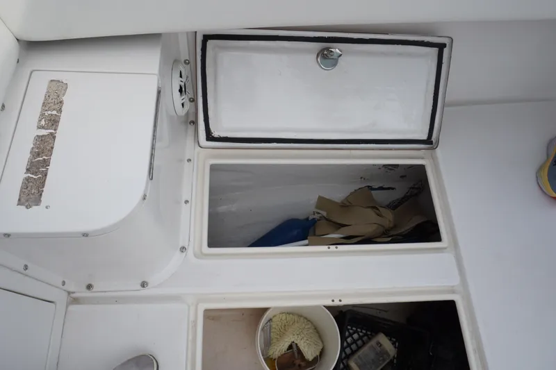 Slide: The Image of 2006 Contender 36 Cuddy storage compartments and deck view. - 27