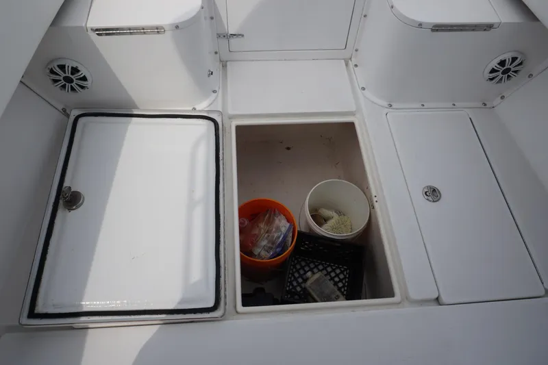 Slide: The Image of 2006 Contender 36 Cuddy storage compartments with fishing gear. - 31