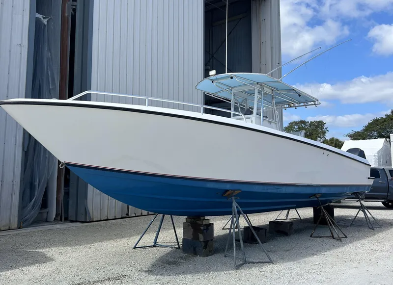 Slide: The Image of 2006 Contender 36 Cuddy boat on stands outside a storage facility. - 33