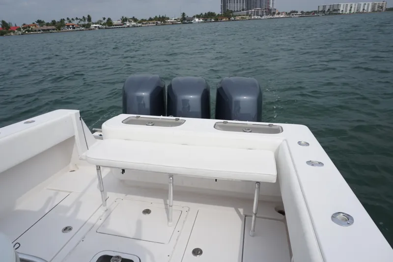 Slide: The Image of 2006 Contender 36 Cuddy boat with triple outboard engines on the water. - 8