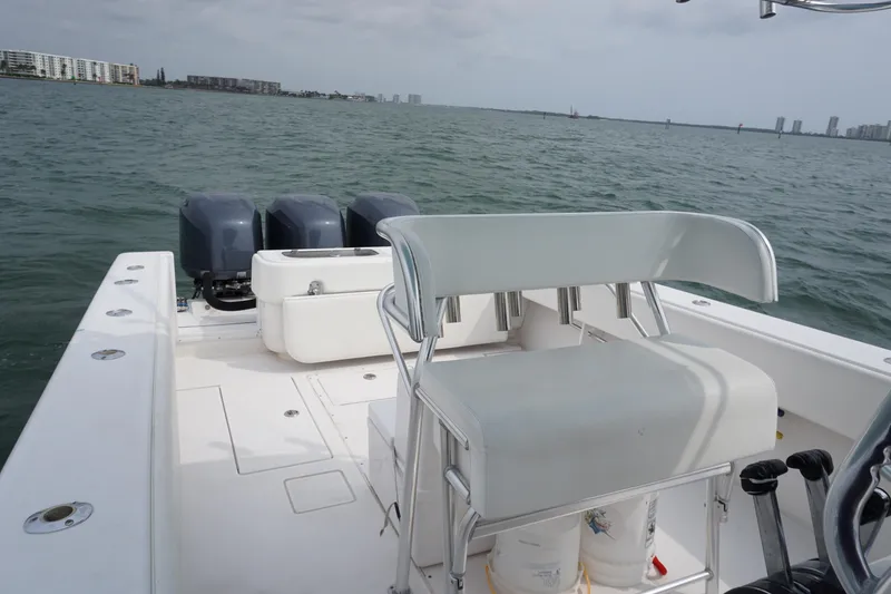 Slide: The Image of 2006 Contender 36 Cuddy boat with triple outboard engines on open water. - 9