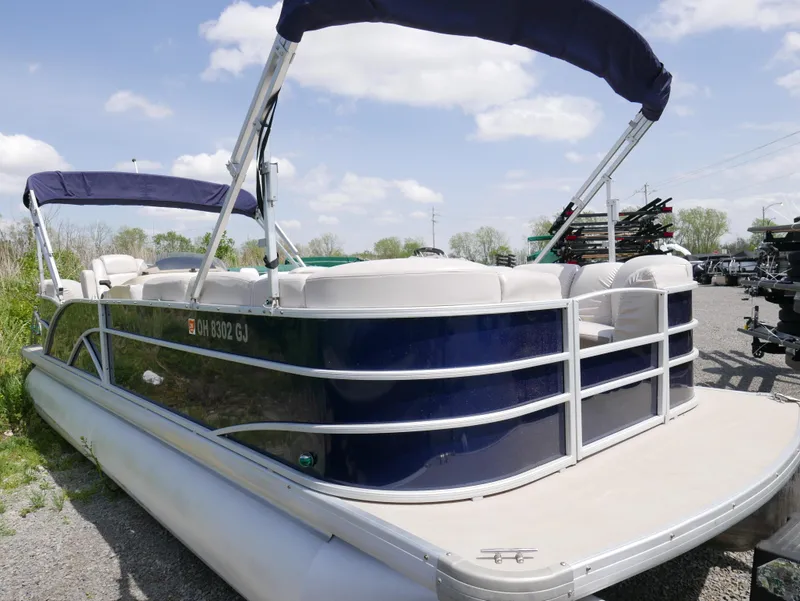 Slide: The Image of 2017 Sweetwater SWPE 255 SB pontoon boat with blue and white exterior. - 10