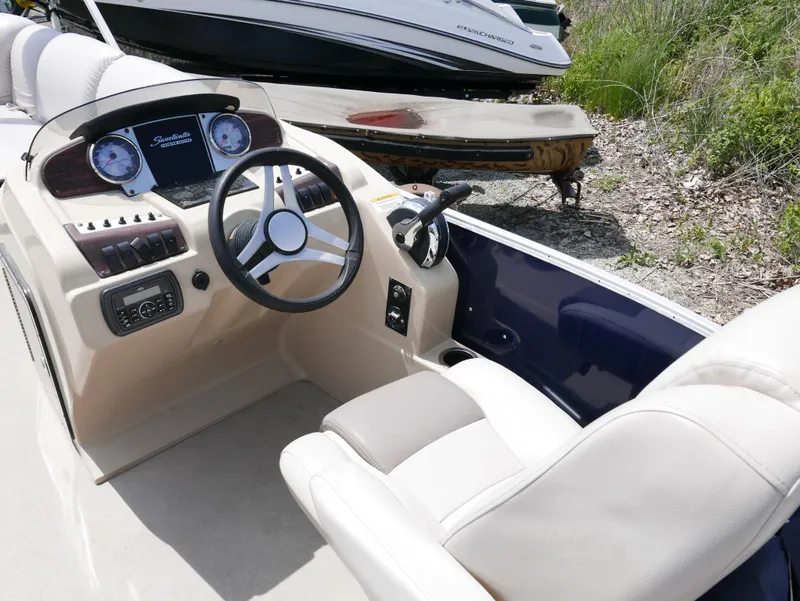 Slide: The Image of 2017 Sweetwater SWPE 255 SB boat cockpit with steering wheel and control panel. - 5