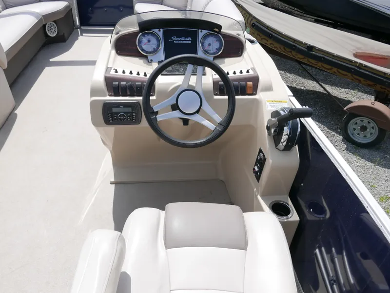 Slide: The Image of 2017 Sweetwater SWPE 255 SB boat cockpit with steering wheel and control panel. - 6