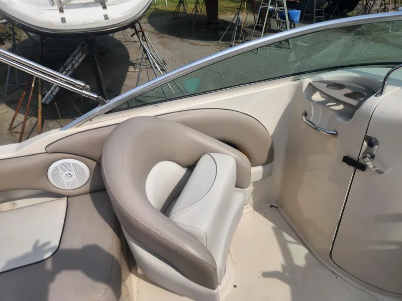 Slide: The Image of 2003 Sea Ray 220 Sundeck boat interior with beige seating and speaker. - 11