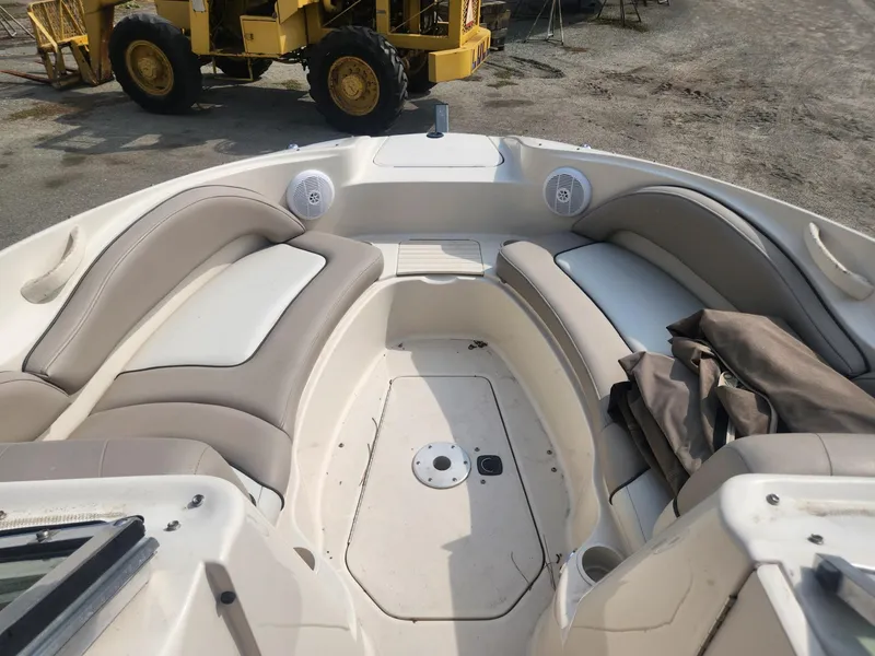 Slide: The Image of 2003 Sea Ray 220 Sundeck boat interior with beige seating and storage compartments. - 8