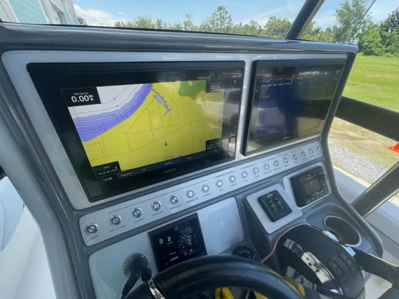Slide: The Image of Dashboard of a 2020 ShearWater 270 Carolina Flare boat with navigation screens. - 18