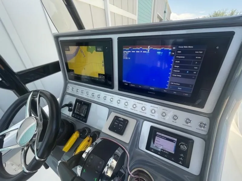 Slide: The Image of 2020 ShearWater 270 Carolina Flare boat dashboard with navigation and control screens. - 19