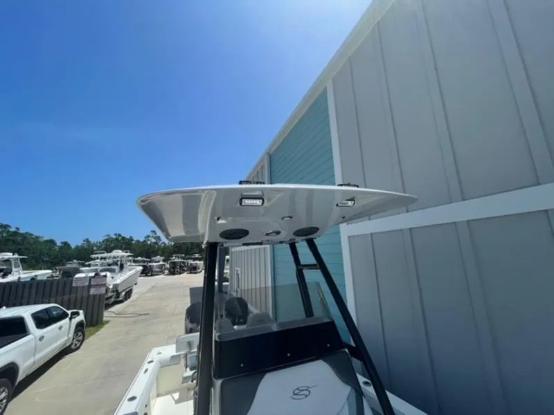 Slide: The Image of 2020 ShearWater 270 Carolina Flare boat docked near a storage facility. - 2