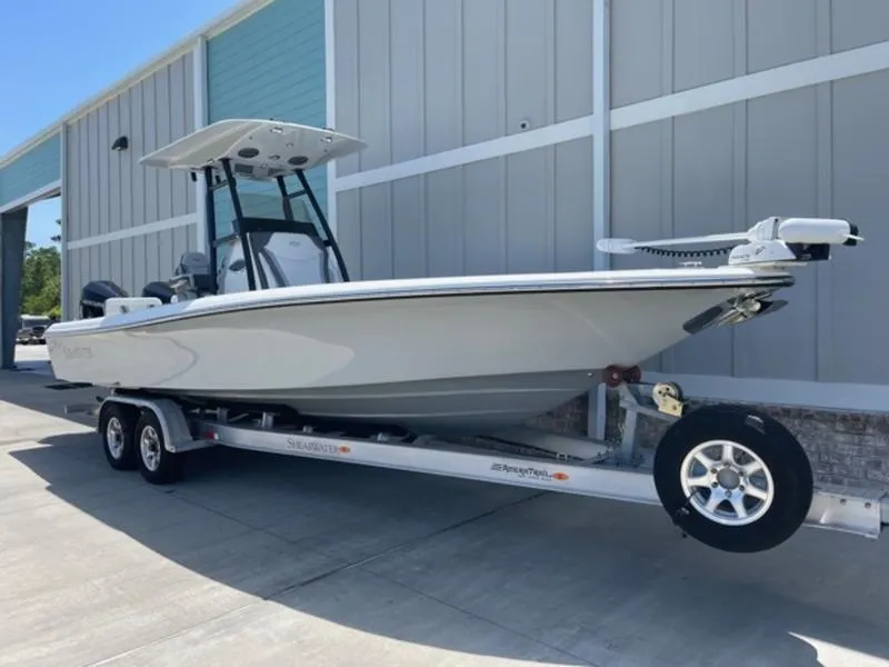 Slide: The Image of 2020 ShearWater 270 Carolina Flare boat on trailer outside a building. - 7