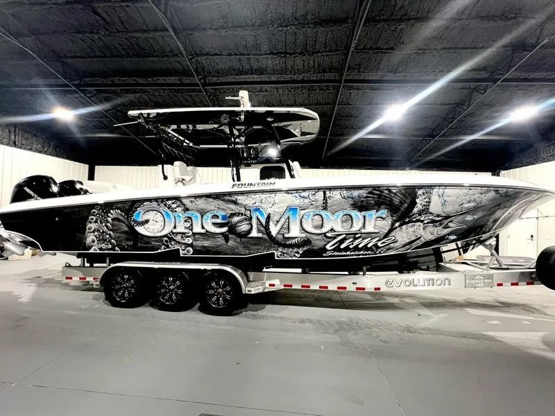 The Image of 2022 Fountain 34 TE boat One Moon Time on a trailer in a warehouse. - 1