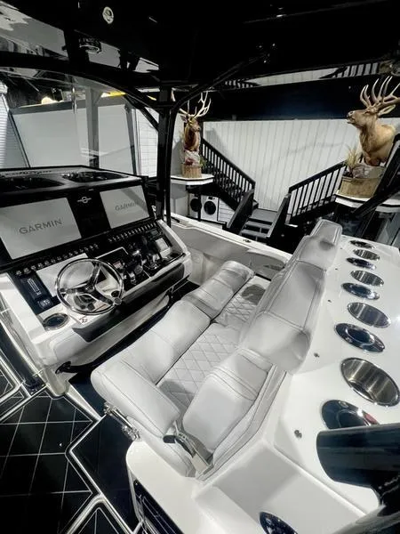 Slide: The Image of 2022 Fountain 34 TE boat interior with advanced Garmin navigation system and luxurious seating. - 16