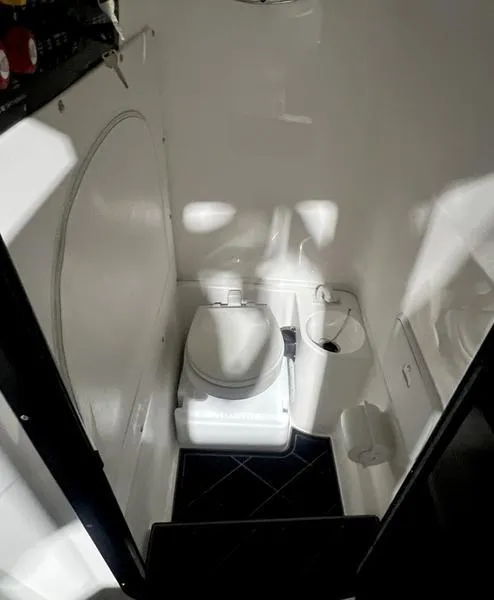 Slide: The Image of 2022 Fountain 34 TE boat interior bathroom with toilet and white walls - 18