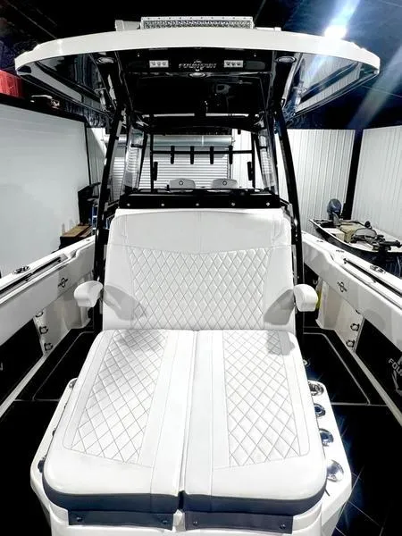 Slide: The Image of 2022 Fountain 34 TE boat with white diamond-stitched seating and modern helm station. - 19